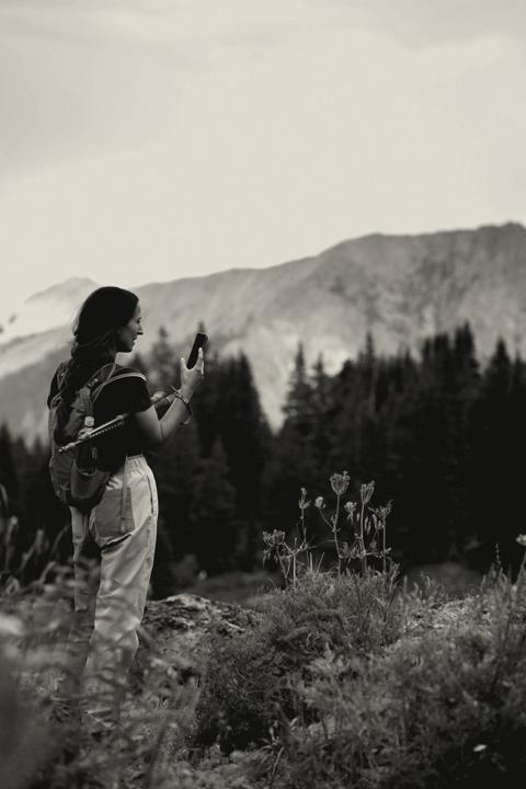 Woman hiker with a pack in alpine country